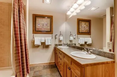 a bathroom with two sinks and a shower at Luxury 1 Bedroom Mountain Condo In River Run Village With Expansive Mountain Views And Walking Distance To Ski Slopes in Keystone