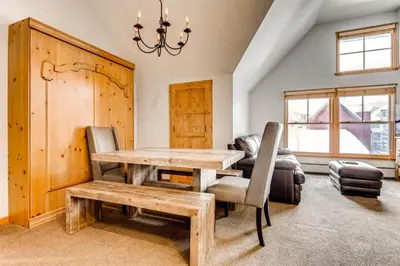 a dining room with a wooden table and chairs at 1 Bedroom Plus Murphy Mountain Condo In River Run Village With Mountain Views And Walking Distance To Ski Slopes in Keystone