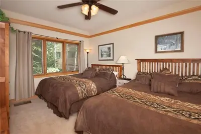 a bedroom with two beds and a ceiling fan at Ski In 2 Bedroom At Chateaux Dumont Keystone in Keystone