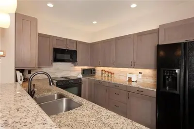 a kitchen with a sink and a counter top at Ski In 2 Bedroom At Chateaux Dumont Keystone in Keystone