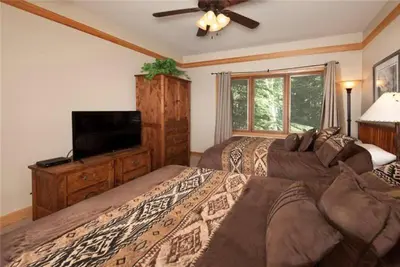 a bedroom with two beds and a flat screen tv at Ski In 2 Bedroom At Chateaux Dumont Keystone in Keystone