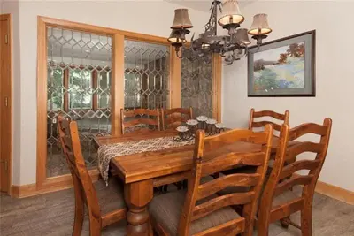 a dining room with a wooden table and chairs at Ski In 2 Bedroom At Chateaux Dumont Keystone in Keystone