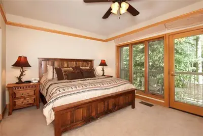 a bedroom with a large bed and a ceiling fan at Ski In 2 Bedroom At Chateaux Dumont Keystone in Keystone