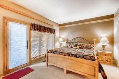 a bedroom with a bed and a large window at Ski In 3 Bedroom At Chateaux Dumont Keystone in Keystone