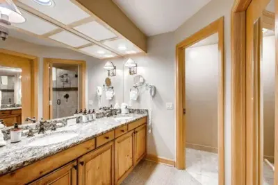 a bathroom with two sinks and a large mirror at Ski In 3 Bedroom At Chateaux Dumont Keystone in Keystone
