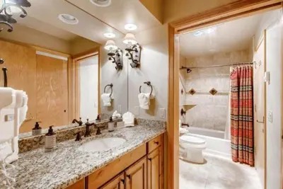 a bathroom with a sink and a toilet and a tub at Ski In 3 Bedroom At Chateaux Dumont Keystone in Keystone