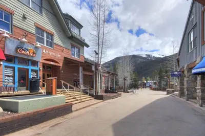 an empty street in a town with a mountain at 3 Bedroom Mountain Condo In River Run Village With Expansive Mountain Views And Walking Distance To Ski Slopes in Keystone