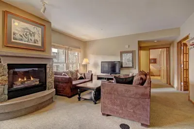 a living room with a fireplace and couches at 3 Bedroom Mountain Condo In River Run Village With Expansive Mountain Views And Walking Distance To Ski Slopes in Keystone