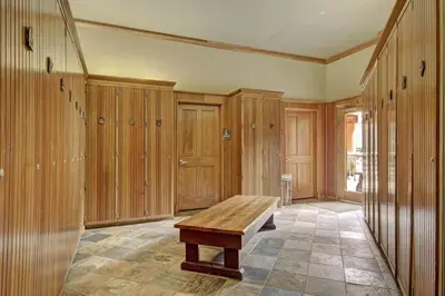 a room with wooden cabinets and a wooden bench at 3 Bedroom Mountain Condo In River Run Village With Expansive Mountain Views And Walking Distance To Ski Slopes in Keystone