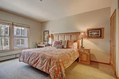 a bedroom with a large bed and a window at 3 Bedroom Mountain Condo In River Run Village With Expansive Mountain Views And Walking Distance To Ski Slopes in Keystone