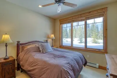 a bedroom with a bed and a large window at Private Family Friendly 2 Bedroom Townhome Located In East Keystone With Access To Free Shuttle Service in Keystone