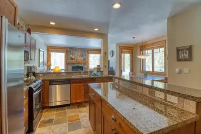a large kitchen with wooden cabinets and granite counter tops at Private Family Friendly 2 Bedroom Townhome Located In East Keystone With Access To Free Shuttle Service in Keystone
