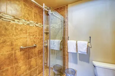 a bathroom with a shower and a toilet and towels at Private Family Friendly 2 Bedroom Townhome Located In East Keystone With Access To Free Shuttle Service in Keystone