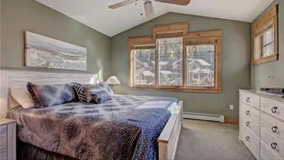 a bedroom with a bed and a window in it at Private 2 Bedroom Townhome Located In East Keystone With Access To A Firepit, Hot Tub, And Billiards in Keystone