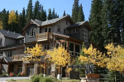 a large house with a balcony on the side of it at Private 3 Bedroom Townhome Located In East Keystone With Access To A Firepit, Hot Tub, And Billiards in Keystone