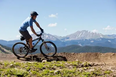 a man riding a bike on a mountain trail at Private 3 Bedroom Townhome Located In East Keystone With Access To A Firepit, Hot Tub, And Billiards in Keystone