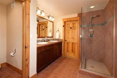 a bathroom with a shower and a sink at Private 3 Bedroom Townhome Located In East Keystone With Access To A Firepit, Hot Tub, And Billiards in Keystone