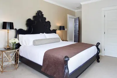 a bedroom with a large black and white bed with a table at Edwards House in Fort Collins