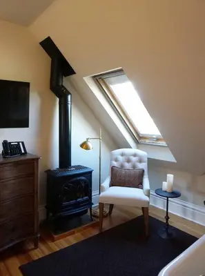 a living room with a chair and a stove at Edwards House in Fort Collins