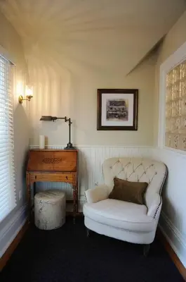 a living room with a white chair and a table at Edwards House in Fort Collins