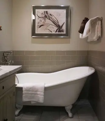 a bathroom with a tub and a sink and a picture at Edwards House in Fort Collins