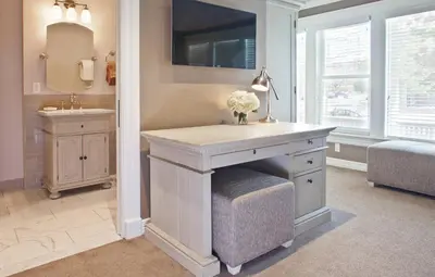 a bathroom with a vanity with a sink and a mirror at Edwards House in Fort Collins