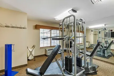 a fitness room with tread machines and a window at Best Western Denver Southwest in Lakewood