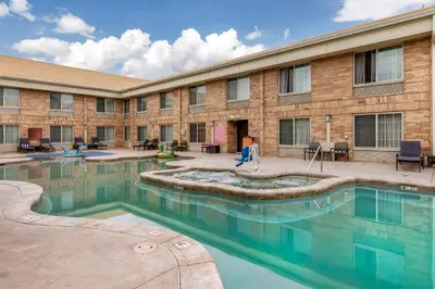 a swimming pool in front of a building at Best Western Denver Southwest in Lakewood