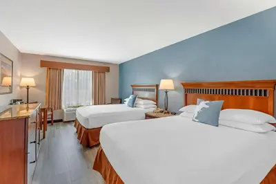 a hotel room with two beds and a bathroom at Best Western Denver Southwest in Lakewood