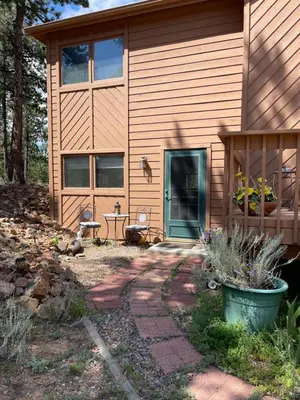 a house with a pathway leading to the front door at On the Divide in Bailey