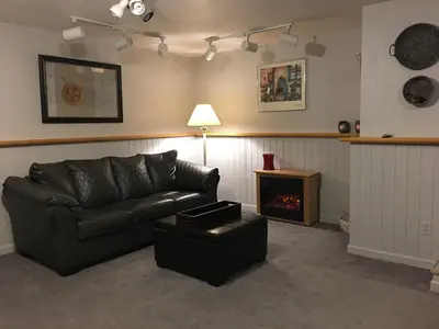 a living room with a couch and a fireplace at On the Divide in Bailey