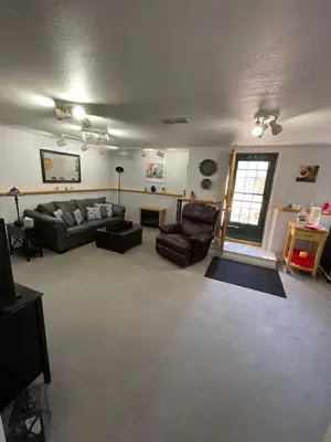 a living room with a couch and chairs and a window at On the Divide in Bailey