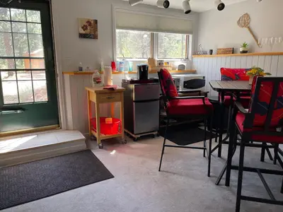 a kitchen with a table and chairs and a kitchen with a table and a window at On the Divide in Bailey