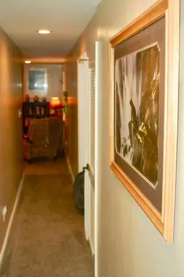a hallway with a painting hanging on a wall at Denver Blue Bear Den 3BR 2BA & Spa in Denver