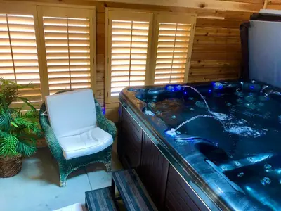 a jacuzzi tub with a chair in a room at Denver Blue Bear Den 3BR 2BA & Spa in Denver