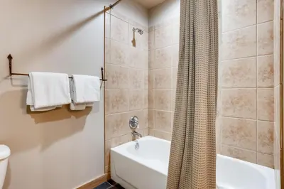 a bathroom with a shower and a toilet and a sink at Premier Red Hawk Lodge 2 Br-Walk To Slopes-Kids Ski Free Condo in Keystone