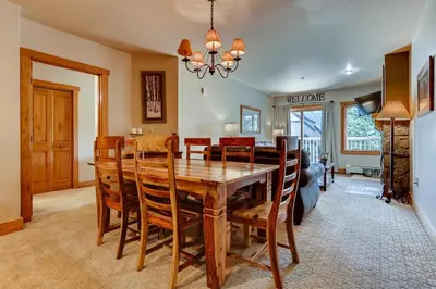 a dining room with a wooden table and chairs at Premier Red Hawk Lodge 2 Br-Walk To Slopes-Kids Ski Free Condo in Keystone