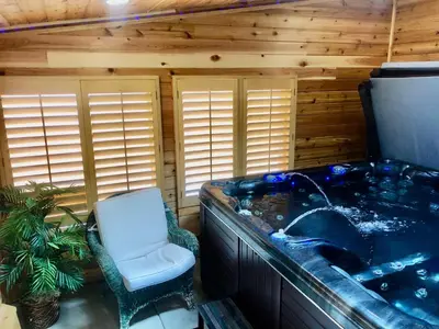 a jacuzzi tub in a room with a chair at Blue Bear Den 3BR 2BA DTC Private Apt Hot Tub in Denver
