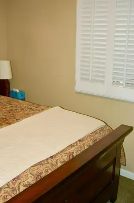 a bed in a room with a window and a bed sidx sidx at Blue Bear Den 3BR 2BA DTC Private Apt Hot Tub in Denver