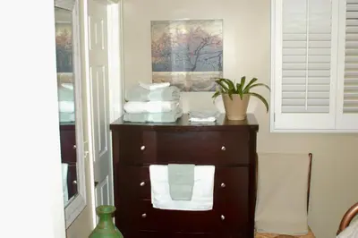 a dresser with towels on it in a room at Blue Bear Den 3BR 2BA DTC Private Apt Hot Tub in Denver