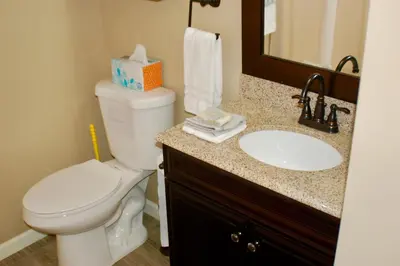 a bathroom with a white toilet and a sink at Blue Bear Den 3BR 2BA DTC Private Apt Hot Tub in Denver