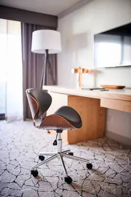 an office chair sitting in front of a desk at Warwick Denver in Denver