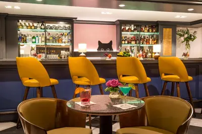 a bar with yellow chairs and a table at Warwick Denver in Denver