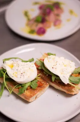 two eggs on top of toast on a white plate at Warwick Denver in Denver