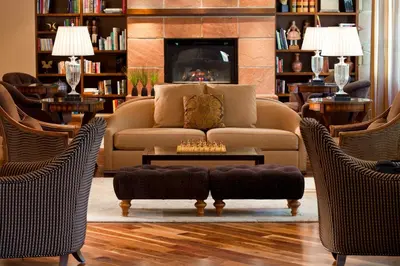 a living room with a couch and two chairs at Warwick Denver in Denver