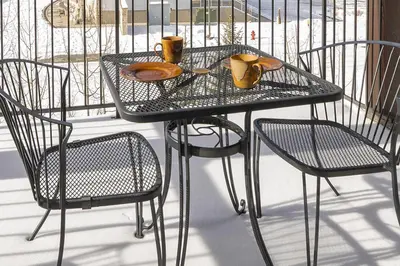a wrought iron table and chairs on a balcony at Trailhead Lodge 734 Condo in Winter Park