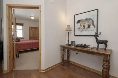 a room with a table with a deer statue on it at Trailhead Lodge 734 Condo in Winter Park