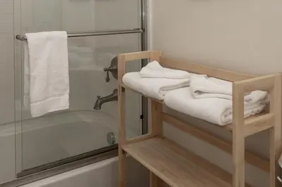 a bathroom with a shower and a bath tub with towels at Trailhead Lodge 734 Condo in Winter Park