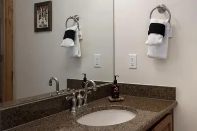 a bathroom with a sink and towels on the wall at Trailhead Lodge 734 Condo in Winter Park