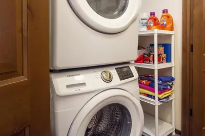 a washing machine with a microwave on top of it at Trailhead Lodge 734 Condo in Winter Park